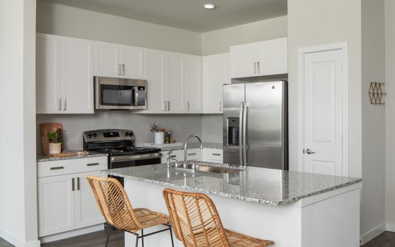 a kitchen with white cabinets