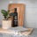 a bottle of wine and a plant on a counter