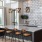a kitchen with a bar and chairs